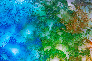 background of dried spilled watercolor blue and green paint