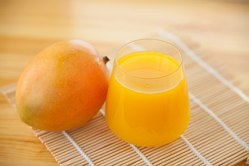 Delicious fresh squeezed mango juice in  transparent glass