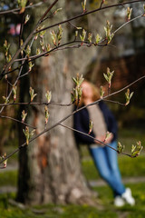 Stockholm, Sweden  A woman enjoys the spring sunshine in a park.