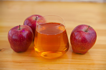 Delicious fresh squeezed apple juice in  transparent glass