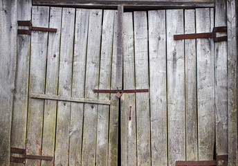 Old wooden gate closed to lock. Copy space.