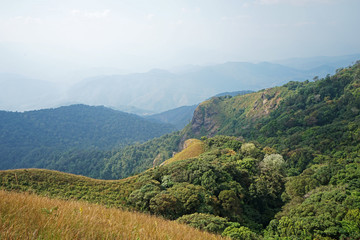 Natural landscape of green mountain range with cloudy blue sky