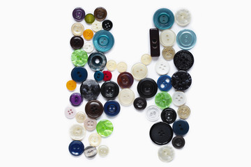 Letter H design made from clothing elements.