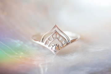 Sterling silver elegant ring in decorative shape on natural white shell background