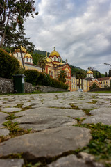 Fototapeta na wymiar Abkhazia, New Athos. View of the monastery with golden domes