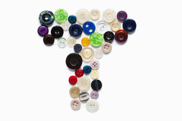 Letter T design made from clothing elements.