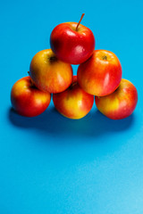 red-yellow juicy apples on a blue background. Healthy Nutrition and Vitamins