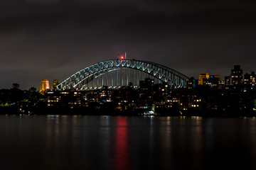 Fototapeta na wymiar Sydney, Australia - 12th February 2020: A German photographer visiting Sydney in Australia, taking pictures of the Harbour Bridge at night.