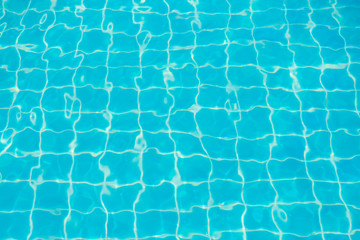 Reflections from the water in the blue swimming pool