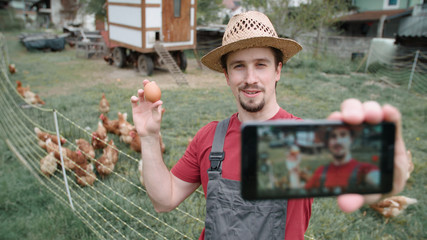Chicken farm influencer record video with smartphone
