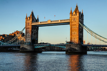 Obraz premium Wonderful and historical Tower bridge across Thames river during sunset and blue sky. Tower Bridge is a combined bascule and suspension bridge. Bridge consists of two bridge towers