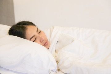 Fototapeta na wymiar Beautiful woman sleeping on white pillow