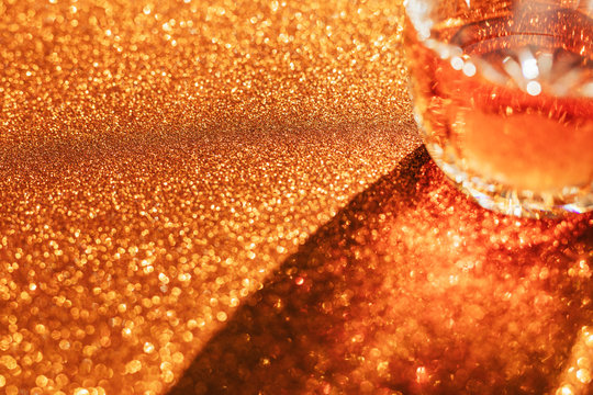 Whisky in a glass on a golden background