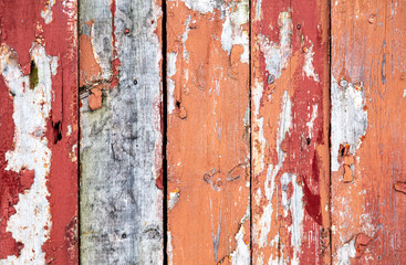 Fototapeta premium Wooden boards on an old red fence as an abstract background.