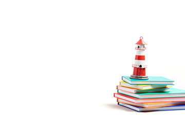 Lighthouse standing on the pile of books. International literacy day, adventures in books, imagination and travel
