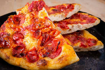 Traditional focaccia bread of Bari made with flour and tomatoes