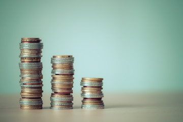 Market crisis and financial aid concept: Coins tacked on each other. Inflation, currency, savings,...