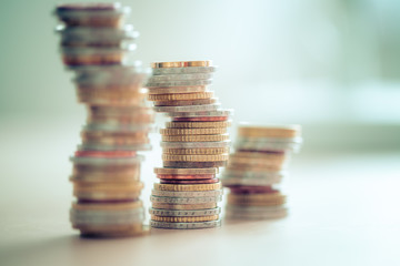 Market crisis and financial aid concept: Coins tacked on each other. Inflation, currency, savings,...