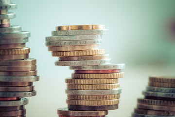 Market crisis and fragile market concept: Coins tacked on each other.