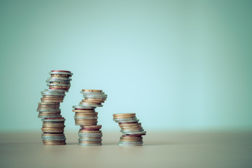 Market crisis and fragile market concept: Coins tacked on each other.