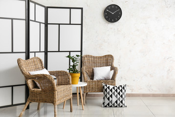 Interior of modern room with wicker armchairs