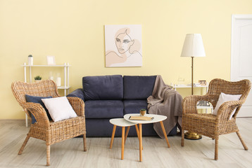 Interior of modern room with wicker armchairs and sofa