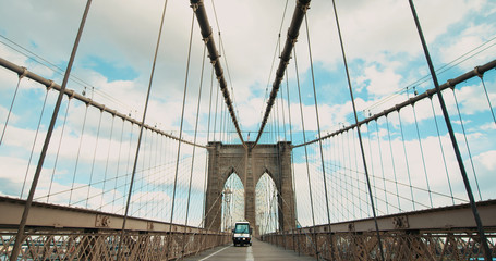 Fototapeta premium Police scooter car driving on Brooklyin bridge in New York during COVID-19. No people walking on usually crowded bridge during coronavirus pandemic
