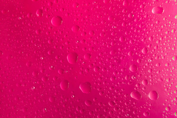 background for design of water drop close up on a pink surface