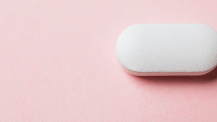 White tablet on a pink background