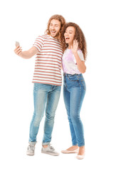 Young couple taking selfie on white background