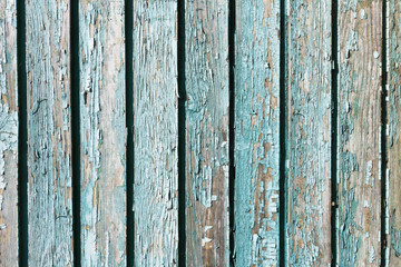 Old peeling paint texture. Grunge cracked wooden wall background. Blue color weathered surface. Broken wood desk structure. Vintage board pattern design.