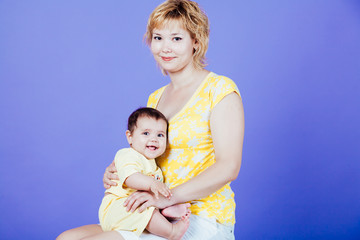 Mama embraces his cute daughter family happy