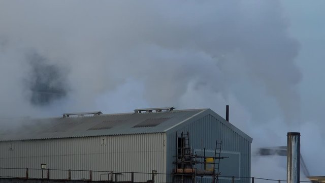 Coal fired power station near manchester pumping out smoke and pollution England UK 4K