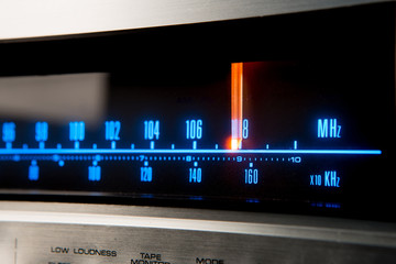 Classic radio tuner panel close-up. Black background
