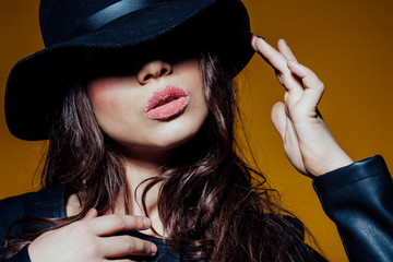 girl in the hat posing in the Studio