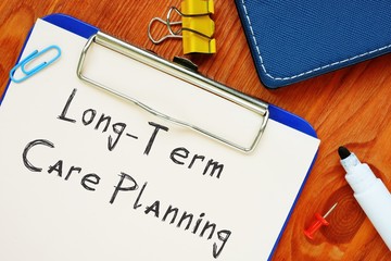 The caption in the picture is Long-Term Care Planning. Notebook sheet, table, pens.