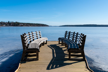 First day spring on lake Malaren near Sigtuna, Sweden. Bright blue sky. Ice water.