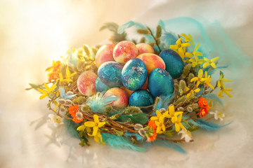 Colorful easter egg and nest on green pastel color background.