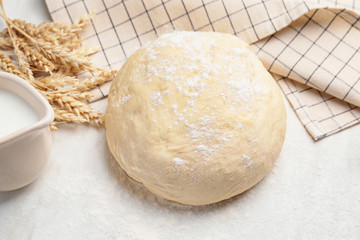 Fototapeta na wymiar Fresh dough with milk on white background