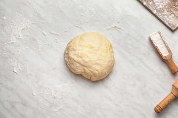 Fresh dough and flour on white background