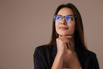 Photo of charming businesswoman in eyeglasses posing and looking upward