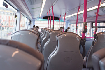 Bus seats and stop button. Passenger's perspective view.