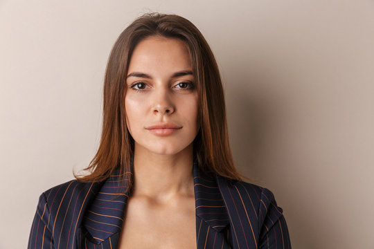 Photo of young businesswoman posing and looking at camera