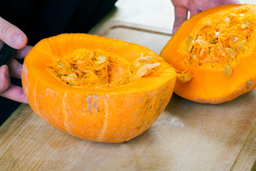 Cut pumpkin on rustic wooden table
