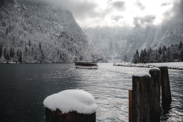 boat on the lake during winter surrounded by mountains