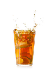 Glass of tasty cold ice tea with splash on white background