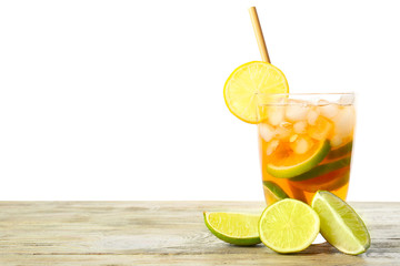Glass of tasty cold ice tea on table against white background