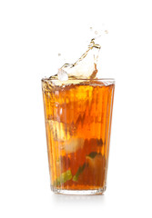Glass of tasty cold ice tea with splash on white background