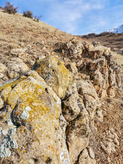 The rock erodes against the sky with clouds.