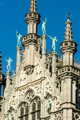 Fototapeta na wymiar Statues on the roof of the Gothic Revival style Maison du Roi / Broodhuis building the Brabantine Gothic style facades on Grand Place in Brussels Belgium